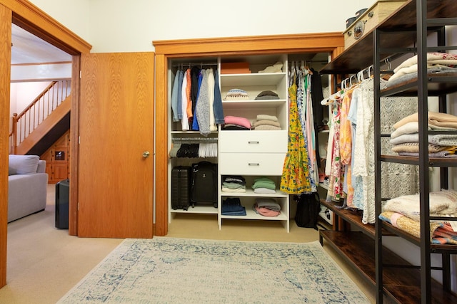 walk in closet featuring light carpet