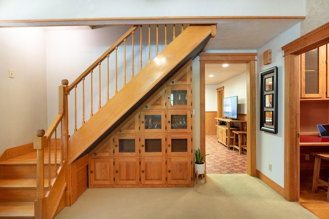 staircase featuring carpet flooring