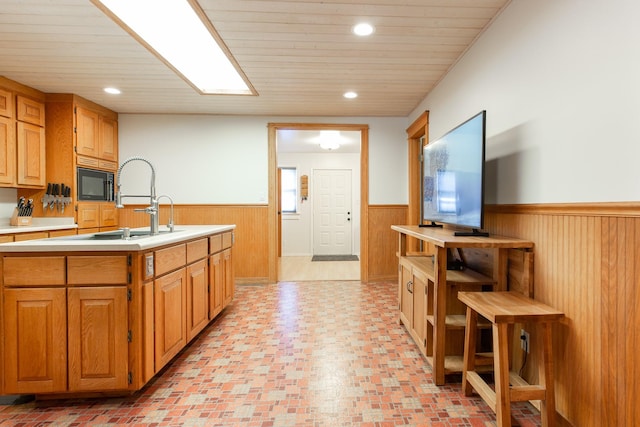 kitchen with wood ceiling and black microwave