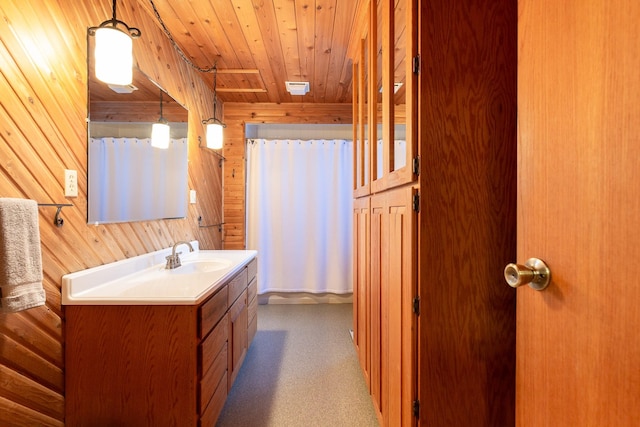 bathroom with curtained shower, wood walls, vanity, and wood ceiling