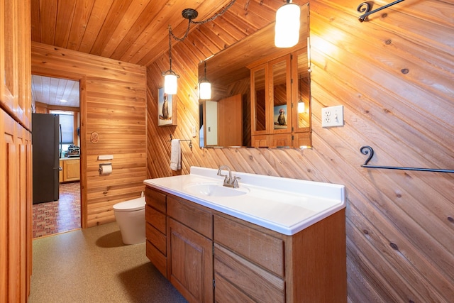 bathroom featuring vanity, wooden ceiling, and toilet