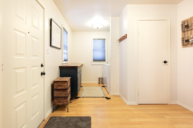 corridor with light wood-type flooring