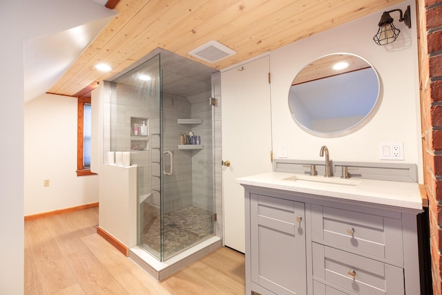 bathroom with vanity, hardwood / wood-style flooring, walk in shower, and wooden ceiling