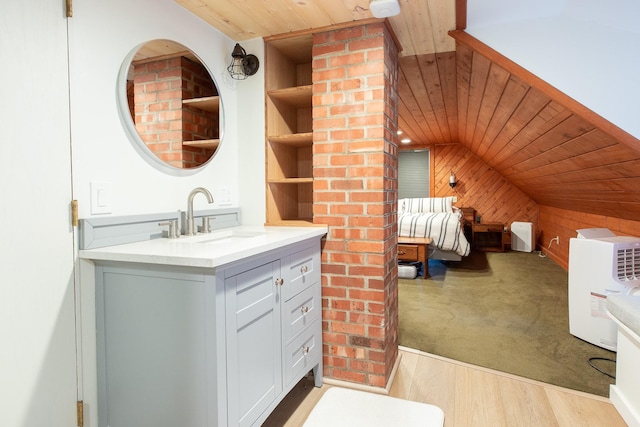 bathroom featuring lofted ceiling, wooden ceiling, wooden walls, hardwood / wood-style flooring, and built in features