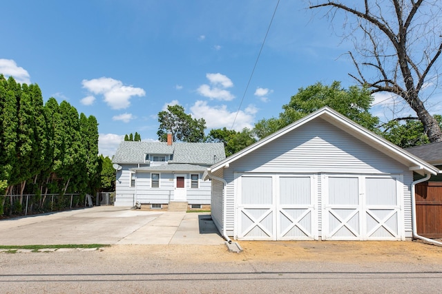 view of front facade with a garage and an outbuilding