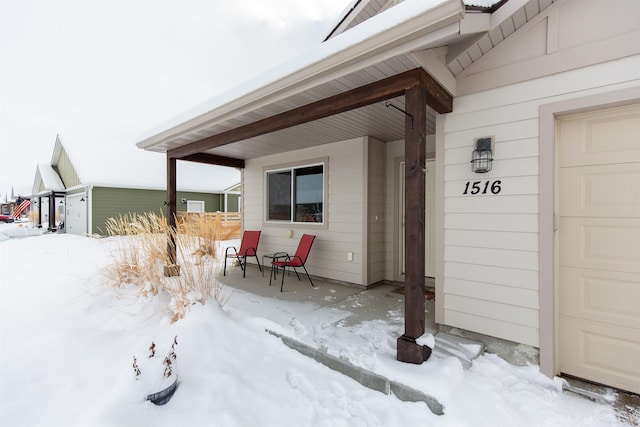 view of snow covered property entrance