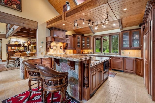 bar with decorative backsplash, light stone counters, stainless steel microwave, and wooden ceiling