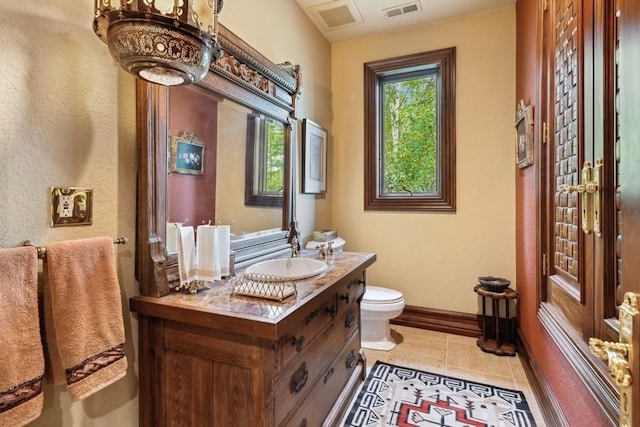 bathroom with tile patterned floors, vanity, and toilet