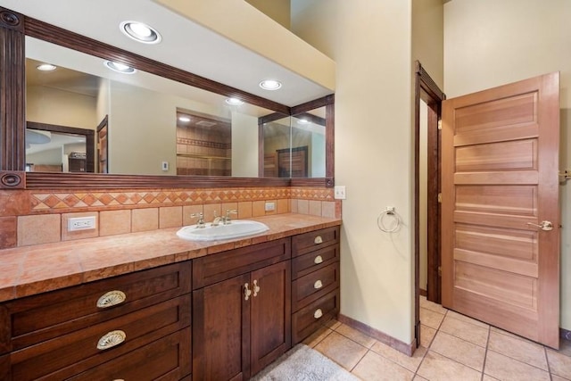 bathroom with decorative backsplash, tile patterned flooring, and vanity