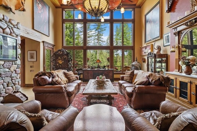 living room with hardwood / wood-style flooring, a notable chandelier, and a high ceiling