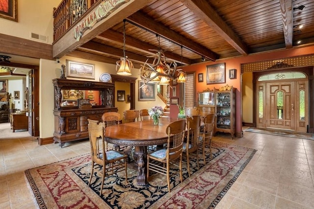 dining space featuring beamed ceiling, wood ceiling, and a notable chandelier