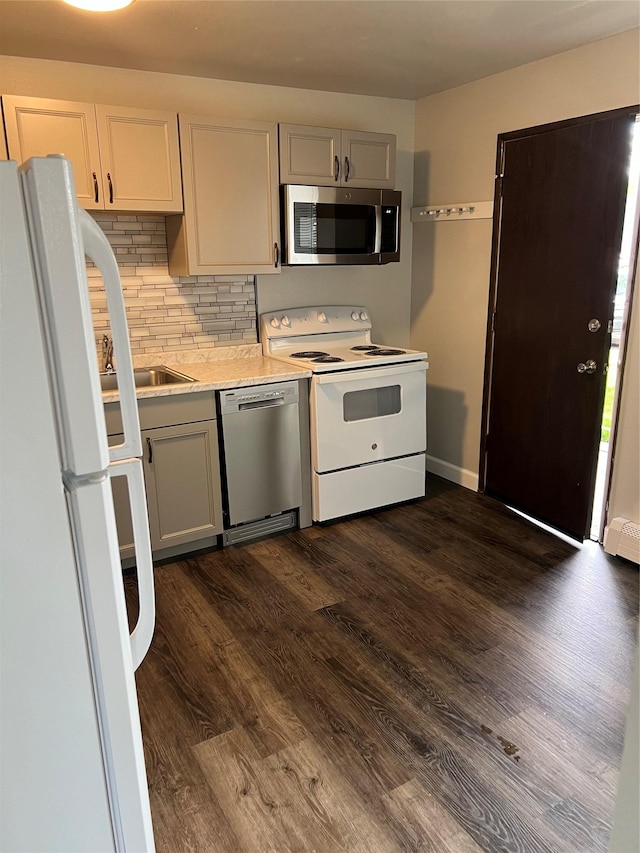 kitchen with white cabinetry, decorative backsplash, dark hardwood / wood-style floors, and appliances with stainless steel finishes