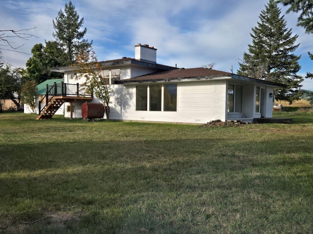 back of house with a yard and a wooden deck