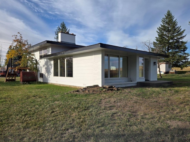 rear view of house with a yard