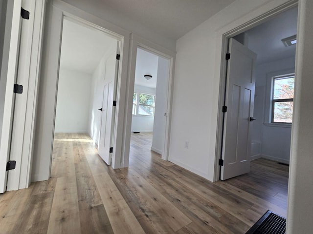 hallway with wood-type flooring