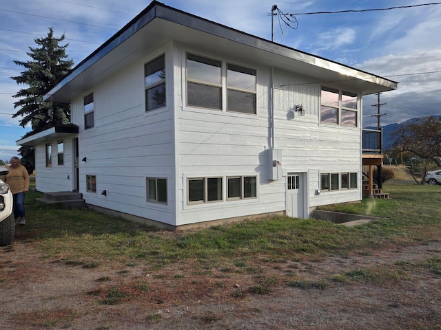 view of side of home with a yard