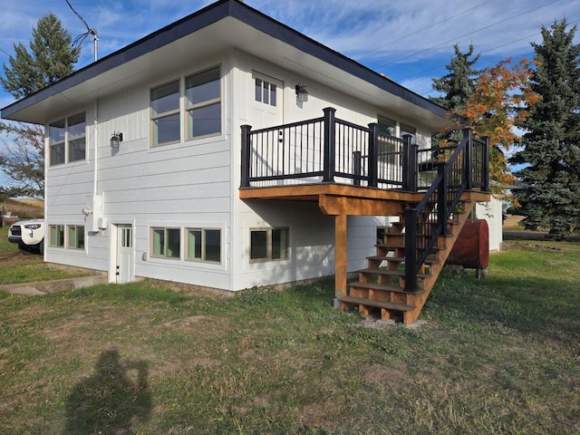 rear view of property featuring a deck and a yard