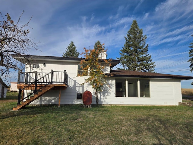 back of house with a yard and a wooden deck