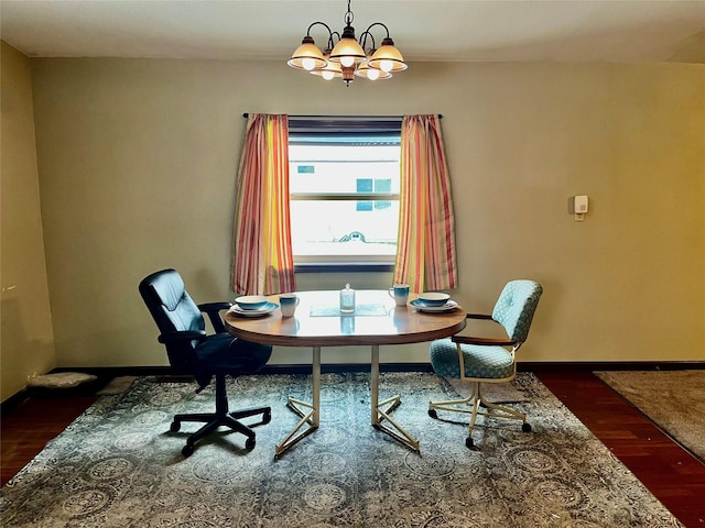 office space with an inviting chandelier and dark wood-type flooring