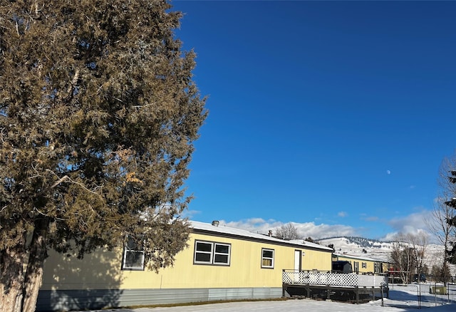 view of snowy exterior featuring a mountain view