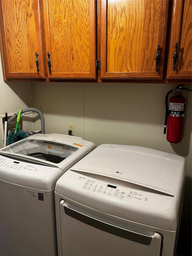 laundry room with cabinets and washing machine and dryer