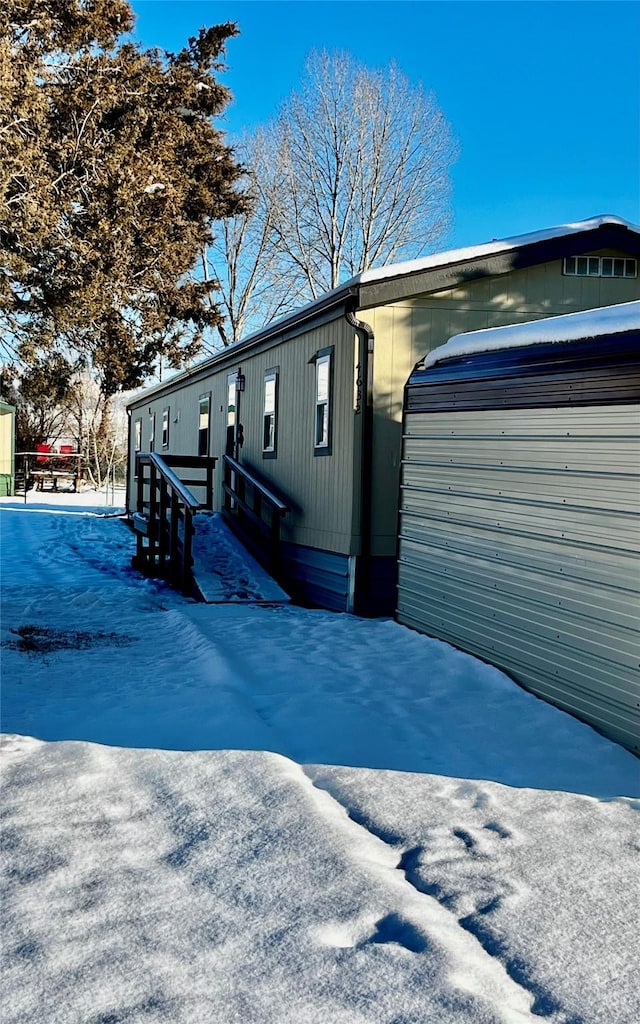 snow covered property featuring a garage