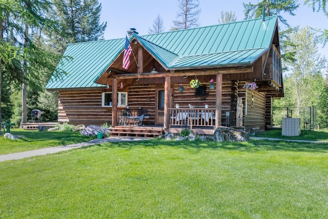 back of house featuring central air condition unit, a yard, and a porch