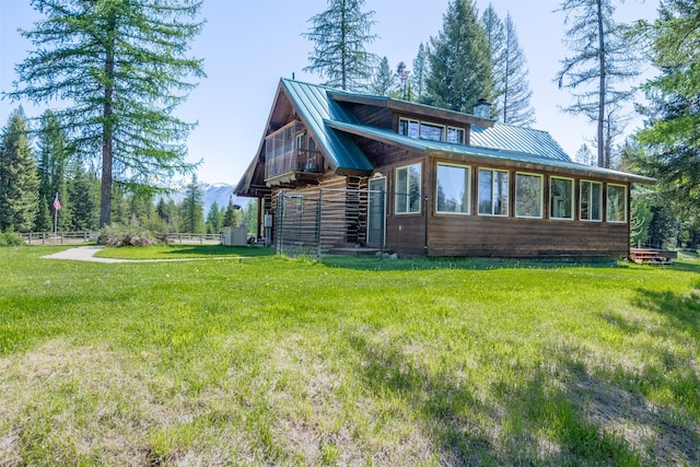 rear view of property featuring a yard