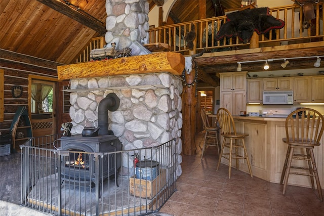 living room featuring wooden ceiling, tile patterned floors, high vaulted ceiling, a wood stove, and beam ceiling