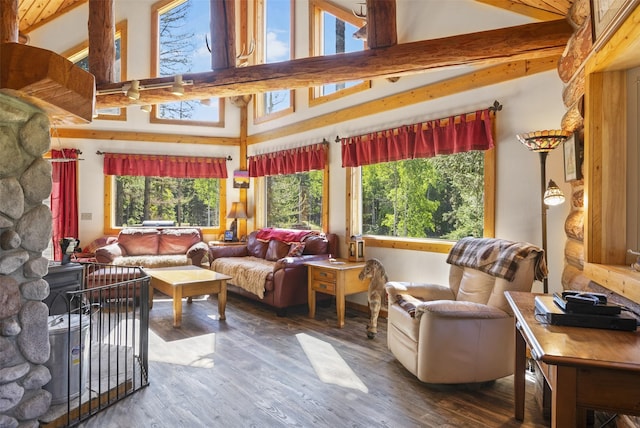 sunroom featuring vaulted ceiling with beams