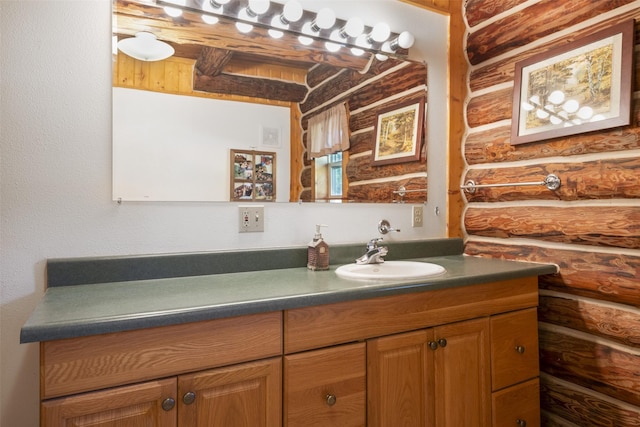 bathroom featuring log walls and vanity