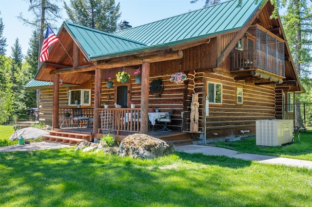 view of front of house with central AC unit, covered porch, and a front lawn