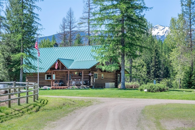 log-style house featuring a mountain view and a front yard