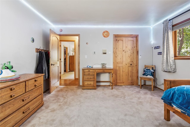 bedroom featuring light carpet