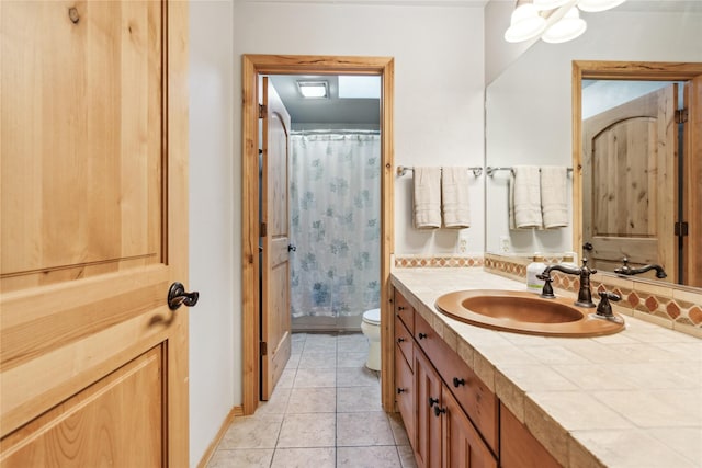 bathroom featuring tile patterned flooring, vanity, a shower with shower curtain, and toilet