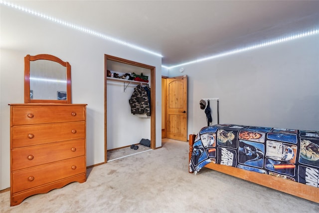 bedroom featuring a closet and light colored carpet