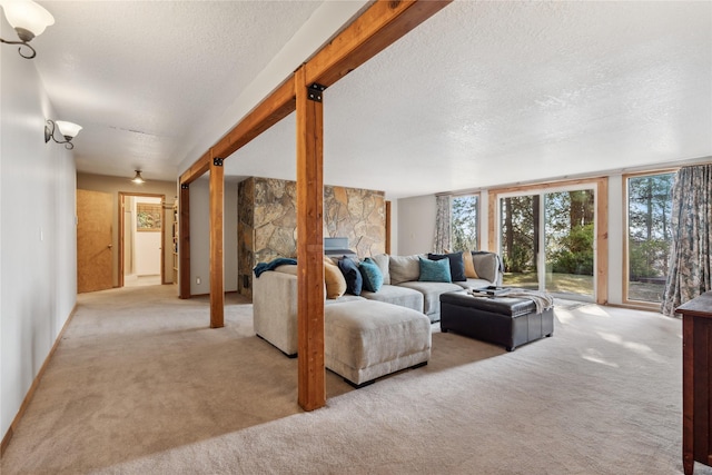 carpeted living room featuring a wealth of natural light and a textured ceiling