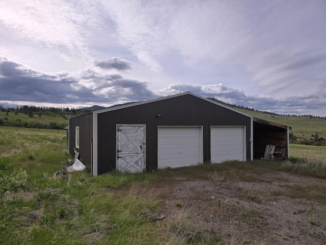 garage featuring a rural view