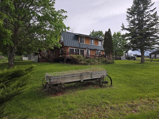 back of house with a wooden deck and a lawn