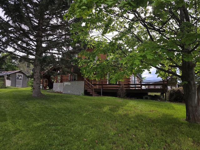 view of yard with a storage shed and a wooden deck