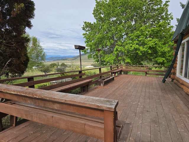 wooden deck with a mountain view