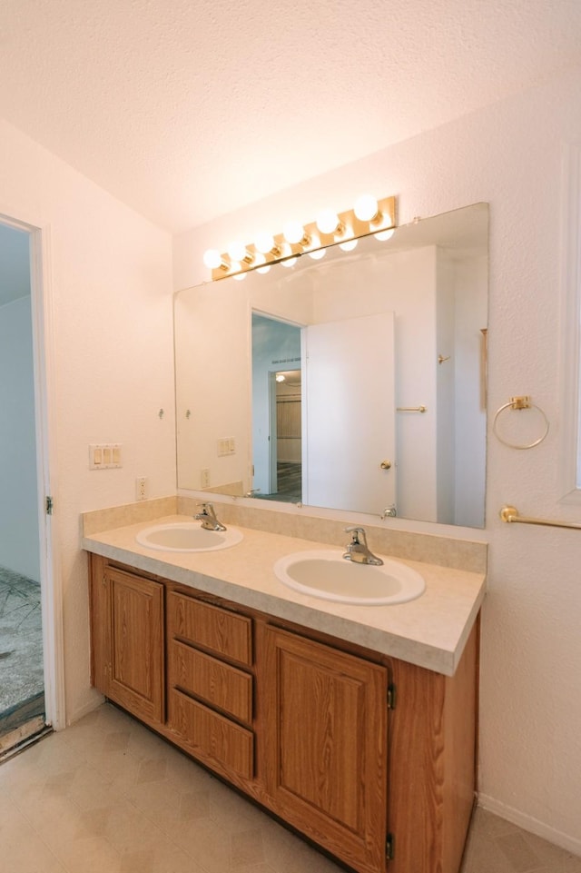 bathroom with vanity and a textured ceiling