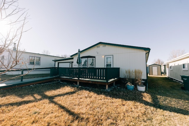 rear view of house featuring a deck and a yard