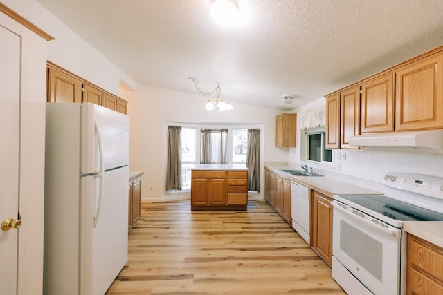 kitchen with white appliances, sink, light hardwood / wood-style flooring, a notable chandelier, and lofted ceiling