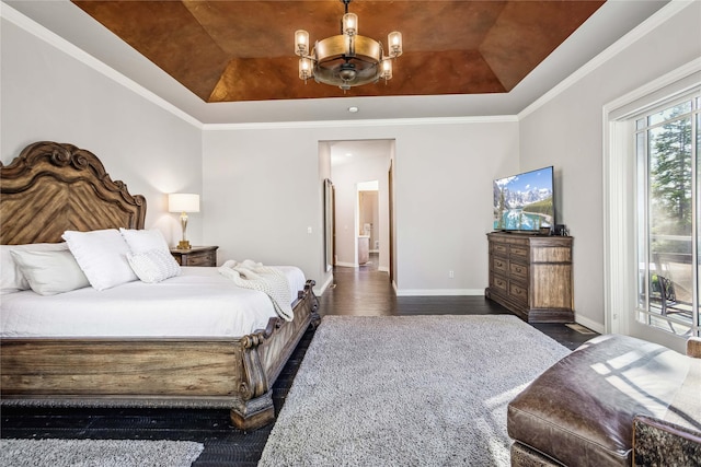 bedroom with access to outside, a tray ceiling, wood finished floors, baseboards, and a chandelier