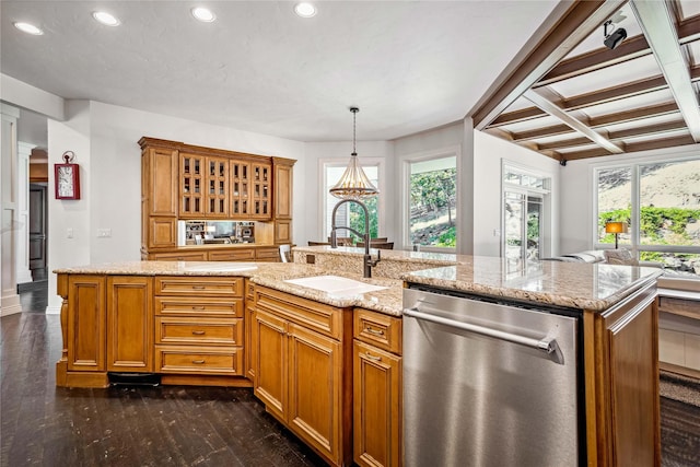 kitchen with dark wood finished floors, a sink, light stone counters, and stainless steel dishwasher