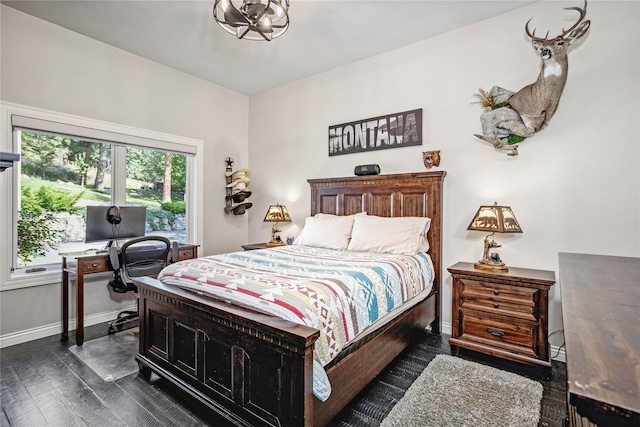 bedroom featuring baseboards and dark wood-style flooring