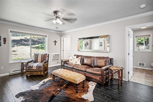 living area with visible vents, a healthy amount of sunlight, a wall mounted air conditioner, and a baseboard heating unit