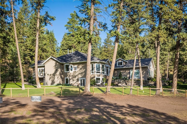 exterior space featuring a lawn and fence