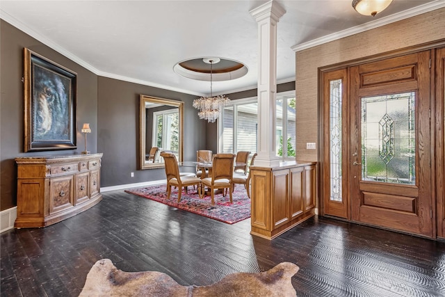 entryway with baseboards, ornate columns, an inviting chandelier, ornamental molding, and dark wood-type flooring